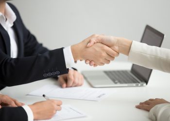 Hr handshaking successful candidate getting hired at new job, closeup